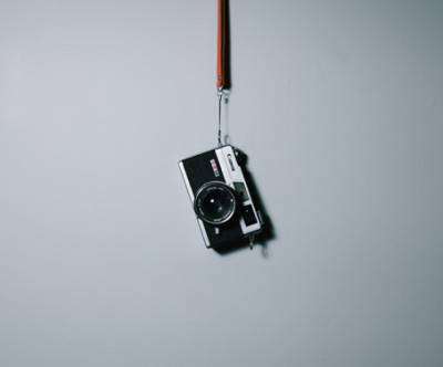 壁に吊るしたコンデジのシンプルな写真