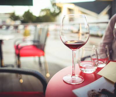 カフェのテラス席に並んだ赤ワインの写真